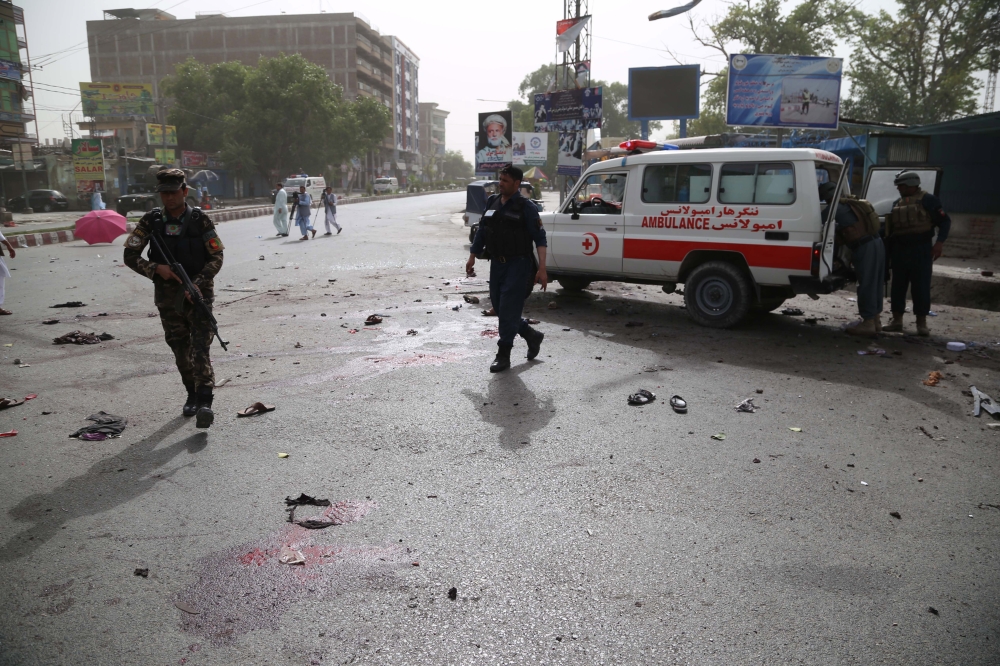 Afghan security officials inspect the scene of a suicide bombing that targeted the participants of a meeting between Taliban militants and the Governor of Nangarhar province, outside the Governor’s office in Jalalabad, Afghanistan, on SUnday. — EPA