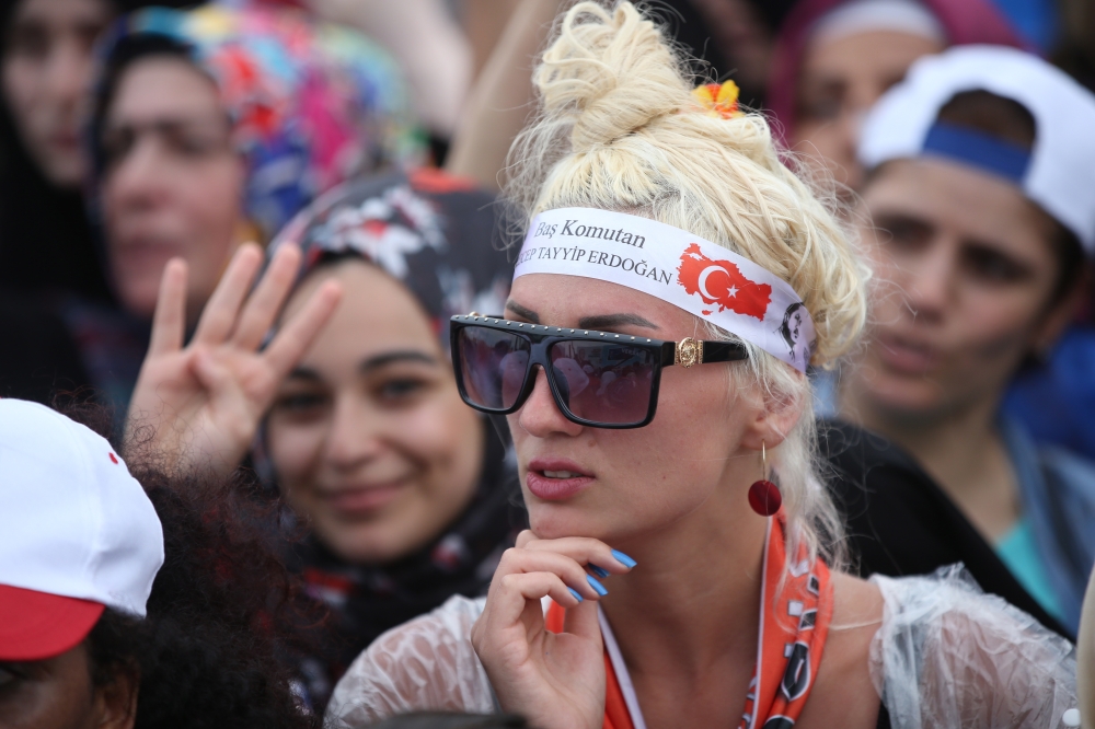 A supporter of Turkish President Recep Tayyip Erdogan wears a bandana with picture of Erdogan  during an election campaign rally of Justice and Development Party (AK Party) in Istanbul, Turkey, on Sunday. — EPA