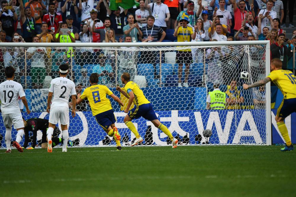 Sweden's defender Andreas Granqvist (4th L) gestures after scoring a penalty during the Russia 2018 World Cup match against South Korea at the Nizhny Novgorod Stadium in Nizhny Novgorod Monday. — AFP
