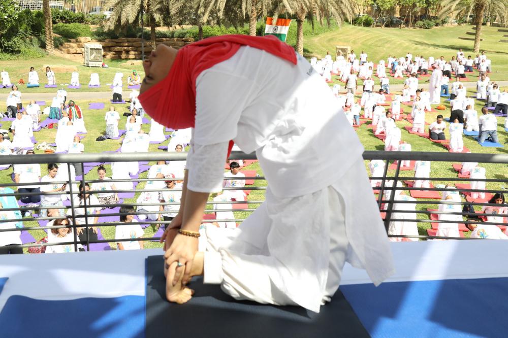 Indian Ambassador Ahmad Javed is seen demonstrating a yoga posture. 