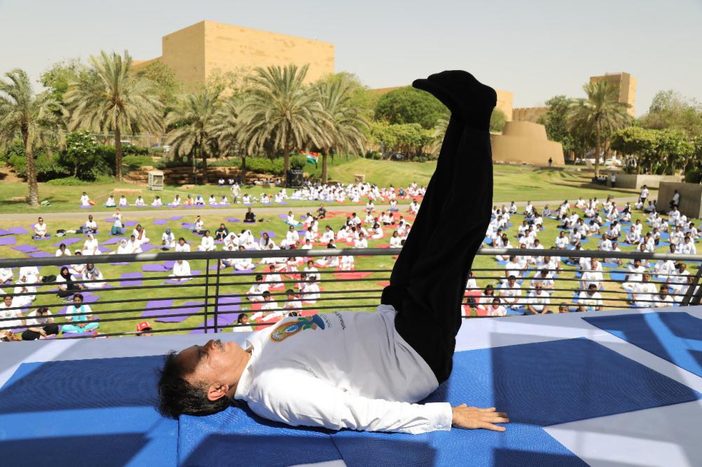 Indian Ambassador Ahmad Javed is seen demonstrating a yoga posture. 