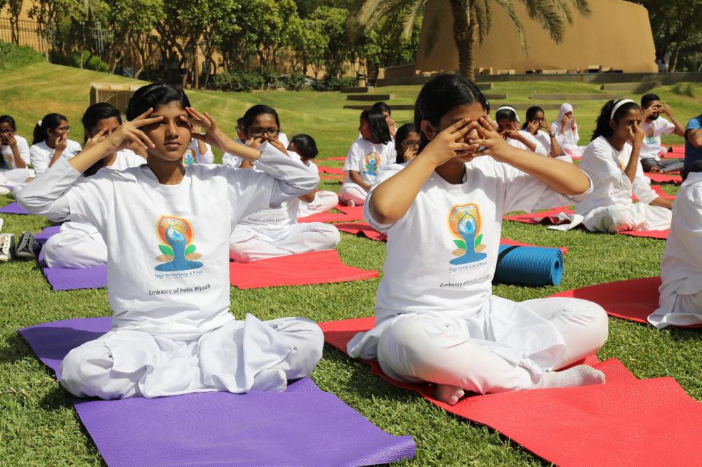 Indian Ambassador Ahmad Javed is seen demonstrating a yoga posture. 