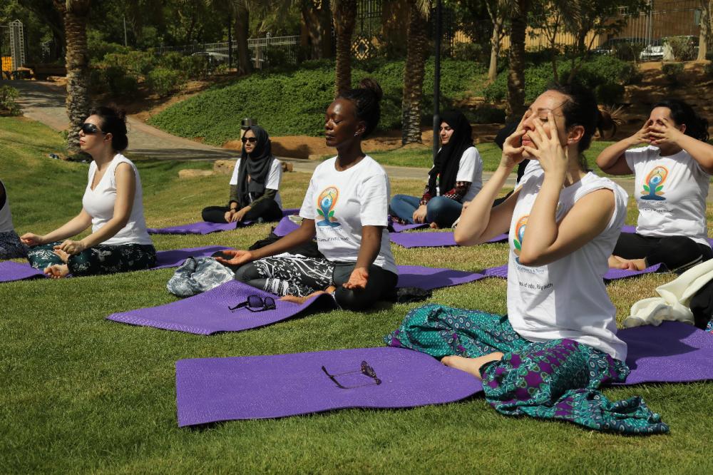 Indian Ambassador Ahmad Javed is seen demonstrating a yoga posture. 