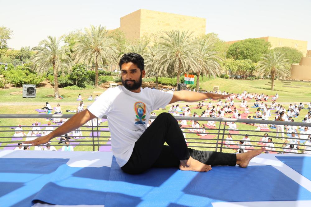 Indian Ambassador Ahmad Javed is seen demonstrating a yoga posture. 