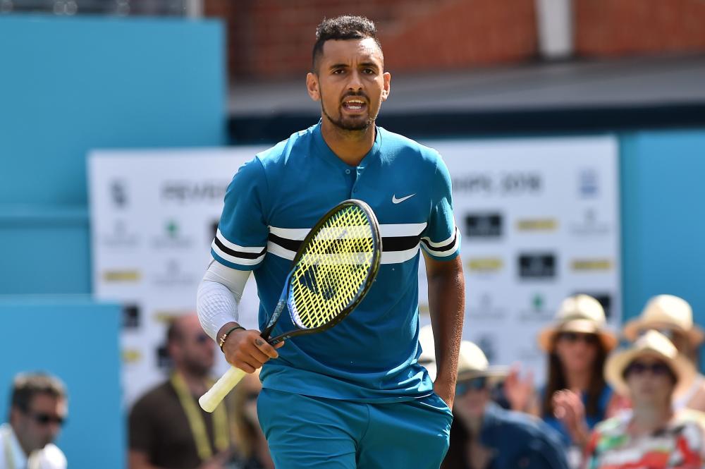 Australia's Nick Kyrgios reacts after winning against Britain's Kyle Edmund at the ATP Queen's Club Championships in west London Thursday. — AFP