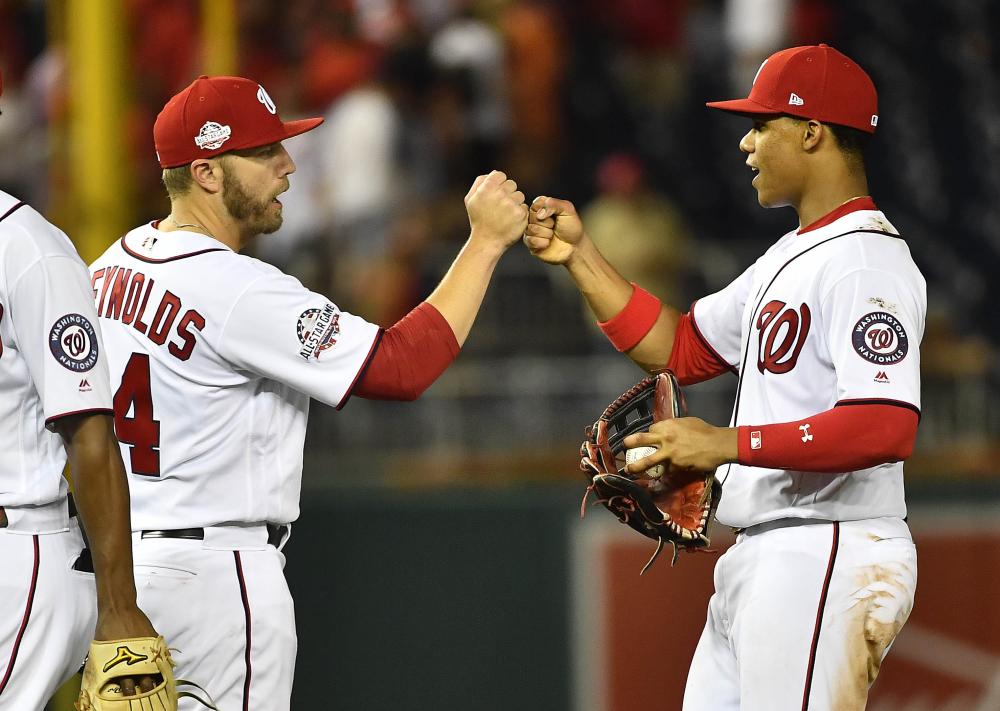 Washington Nationals right fielder Juan Soto is congratulated by first baseman Mark Reynolds (L) after defeating the Baltimore Orioles during their MLB game at Nationals Park in Washington Thursday. — Reuters