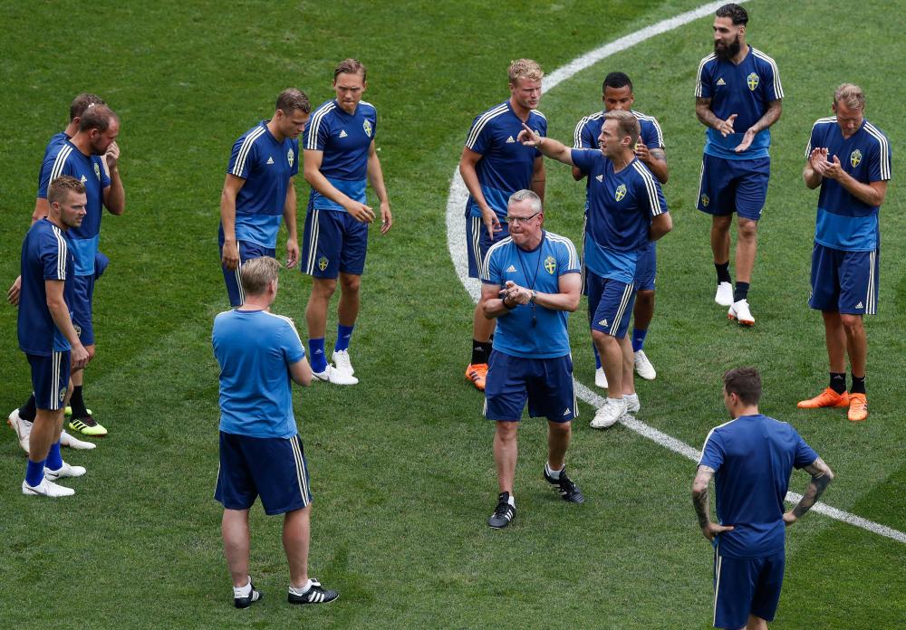 Sweden’s coach Janne Andersson (C) directs players during a training session at the Fisht Olympic Stadium in Sochi Friday. — AFP 