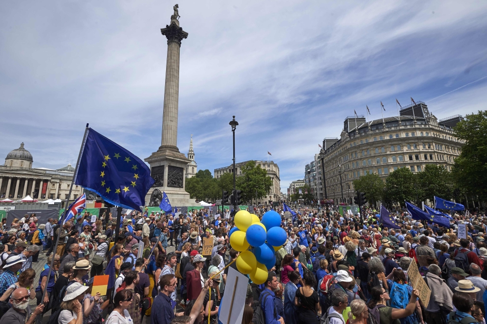 Demonstrators carry banners and flags as they participate in the People’s March demanding a People’s Vote on the final Brexit deal in central London on Saturday, the second anniversary of the 2016 referendum. — AFP