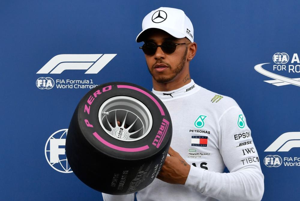 Mercedes' British driver Lewis Hamilton poses with the pole position award as he celebrates at the Circuit Paul Ricard in Le Castellet, southern France, Saturday. — AFP 