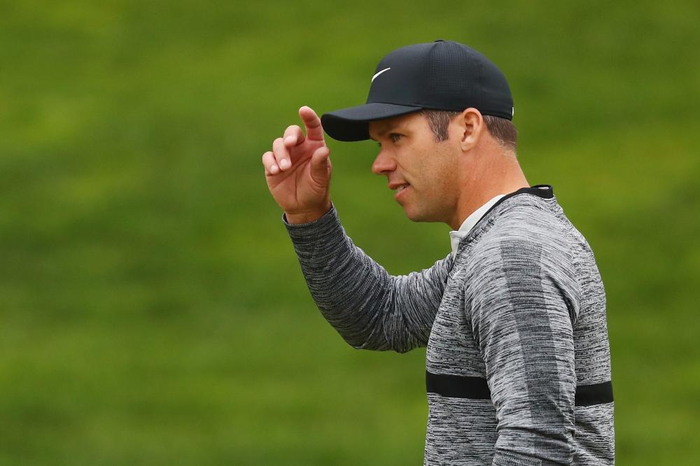 Paul Casey of England gestures to the gallery as he walks on the 18th hole during the third round of the Travelers Championship at TPC River Highlands in Cromwell, Connecticut, Saturday. — AFP 
