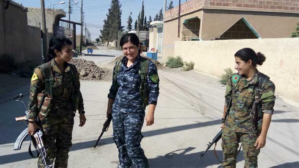 Fighters of the Kurdish Women Protection Units (YPJ) forces guarding a point in Raqqa's Samra village east of the city. — File photo