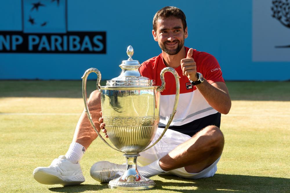 Croatia's Marin Cilic celebrates with the trophy after winning the final against Serbia's Novak Djokovic at the Queen's Club Tennis Championship in London Sunday. — Reuters
