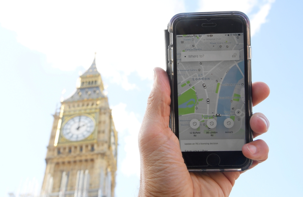 A photo illustration shows the Uber app on a mobile telephone, as it is held up for a posed photograph in central London, Britain, in this Sept. 22, 2017 file photo. — Reuters