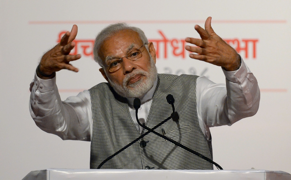 Indian Prime Minister Narendra Modi gestures as he addresses Bharatiya Janata Party (BJP) supporters on the occasion of the 43rd anniversary of the imposition of “the Emergency” period in Mumbai on Tuesday. — AFP
