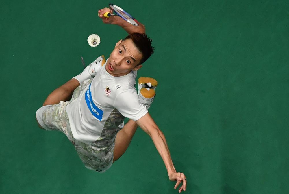 Lee Chong Wei of Malaysia smashes against Tommy Sugiarto of Indonesia in their men's singles semifinal match at the Malaysia Open Badminton Tournament in Kuala Lumpur Saturday. — AFP
