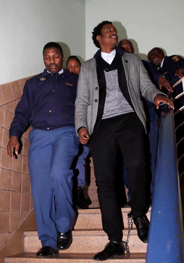 Duduzane Zuma, the son of scandal-plagued former South African President Jacob Zuma, leaves the Johannesburg’s Specialized Commercial Crime court, in shackles after appearing on charges of corruption, in Johannesburg, South Africa, on Monday. — Reuters