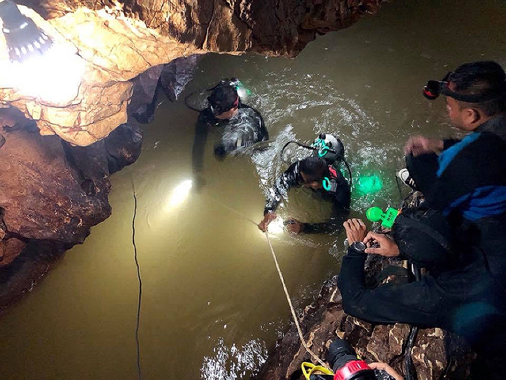 A team of Royal Thai Navy SEAL divers inspects the water-filled tunnel in the Tham Luang cave during a rescue operation for the missing children’s football team and their coach in Chiang Rai province in this June 28, 2018 file photo. — AFP