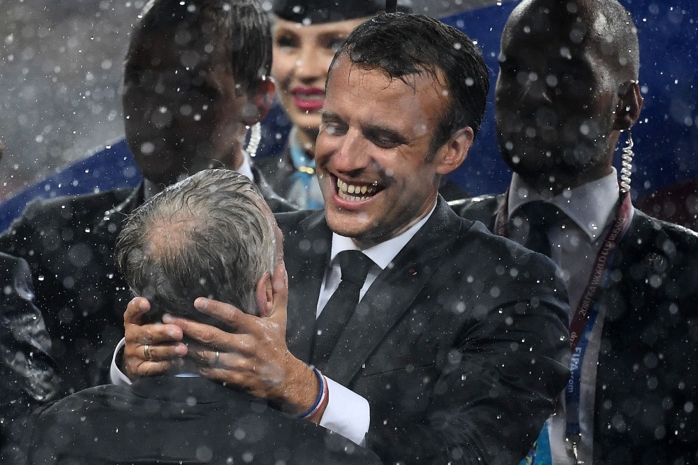 French President Emmanuel Macron (R) congratulates France's coach Didier Deschamps during the trophy ceremony at the end of the Russia 2018 World Cup final football match between France and Croatia at the Luzhniki Stadium in Moscow on Sunday. — AFP