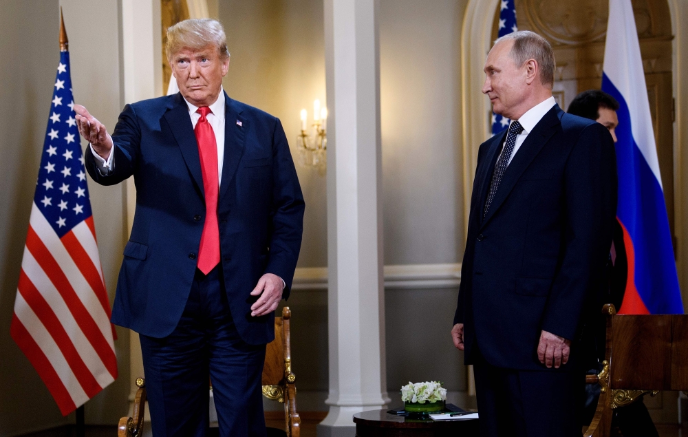 US President Donald Trump (left) and Russia's President Vladimir Putin wait ahead of a meeting in Helsinki, Monday.  — AFP
