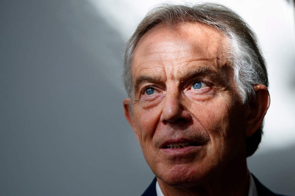 Former British Prime Minister Tony Blair poses for a photograph ahead of an interview  in central London on Tuesday. — AFP