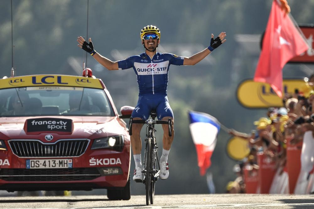 France's Julian Alaphilippe celebrates as he crosses the finish line to win the tenth stage of the 105th edition of the Tour de France cycling race between Annecy and Le Grand-Bornand, French Alps, Tuesday. — AFP