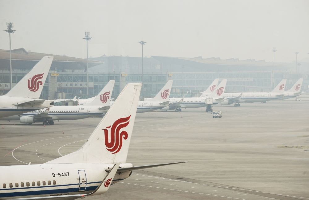 Air China planes are parked at the Beijing Capital International Airport in this April 6, 2017 file photo. — AFP