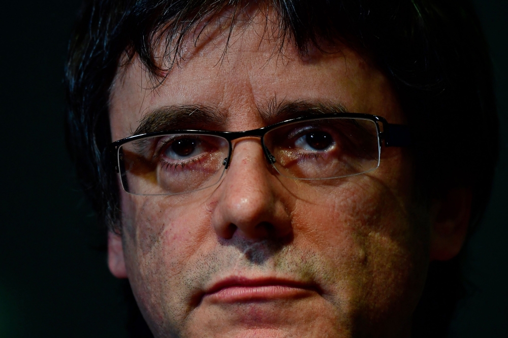 In this file photo, Catalonia's ousted leader Carles Puigdemont addresses a press conference in Berlin. A Spanish judge dropped on Thursday European and international arrest warrants for deposed Catalan president Carles Puigdemont and other separatist leaders who fled abroad, the Supreme Court said, the second time he has done so. In a court ruling, Pablo Llarena said he had taken the decision after a German court agreed to extradite Puigdemont, but only for misuse of public funds and not on the more serious charge of rebellion. — AFP