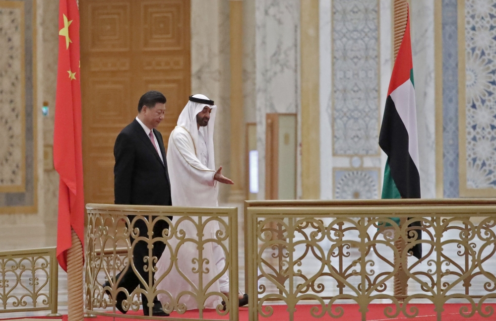 Chinese President Xi Jinping (L) and Crown Prince of Abu Dhabi Sheikh Mohamed bin Zayed Al Nahyan (R) arrive at the presidential palace in the UAE capital on Friday. President Xi Jinping arrived in Abu Dhabi on Thursday for a three-day visit, after the announcement of oil and trade deals between China and the UAE. — AFP