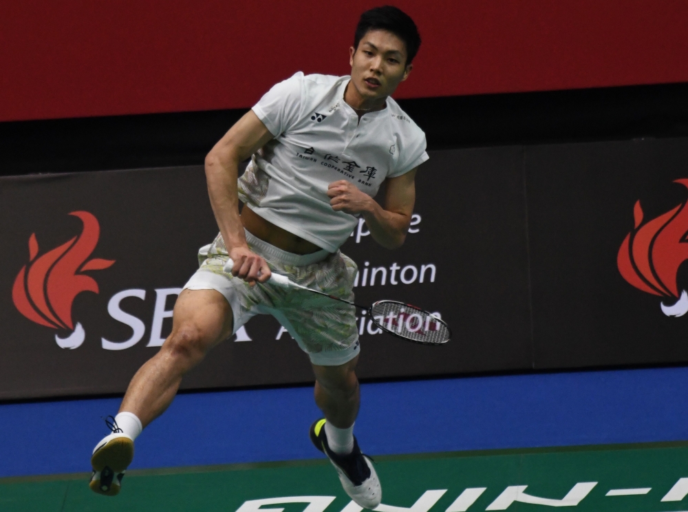 Chou Tien Chen of Taiwan competes against Lee Hyun Il of South Korea during their men's single quarterfinals at the Singapore Open badminton tournament in Singapore on Friday. — AFP
