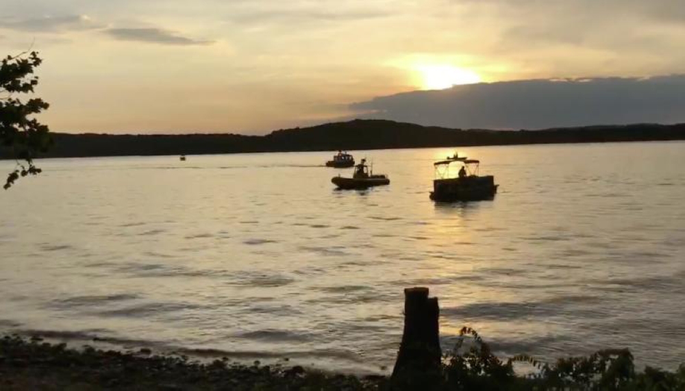 Crews work at the scene where a tourist boat capsized and sank on Thursday during a fierce storm on a lake near Branson, Missouri. — AFP