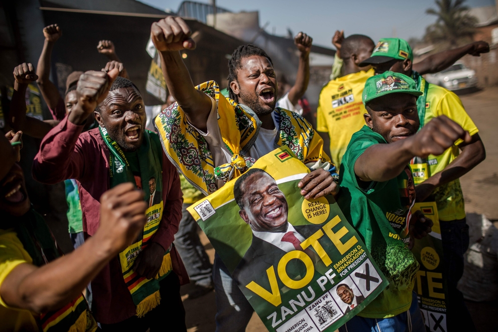 Supporters celebrate after Zimbabwe’s President Emmerson Mnangagwa has been declared the winner in the country’s landmark election, in the suburb of Mbare of Zimbabwe’s capital Harare, on Friday. — AFP