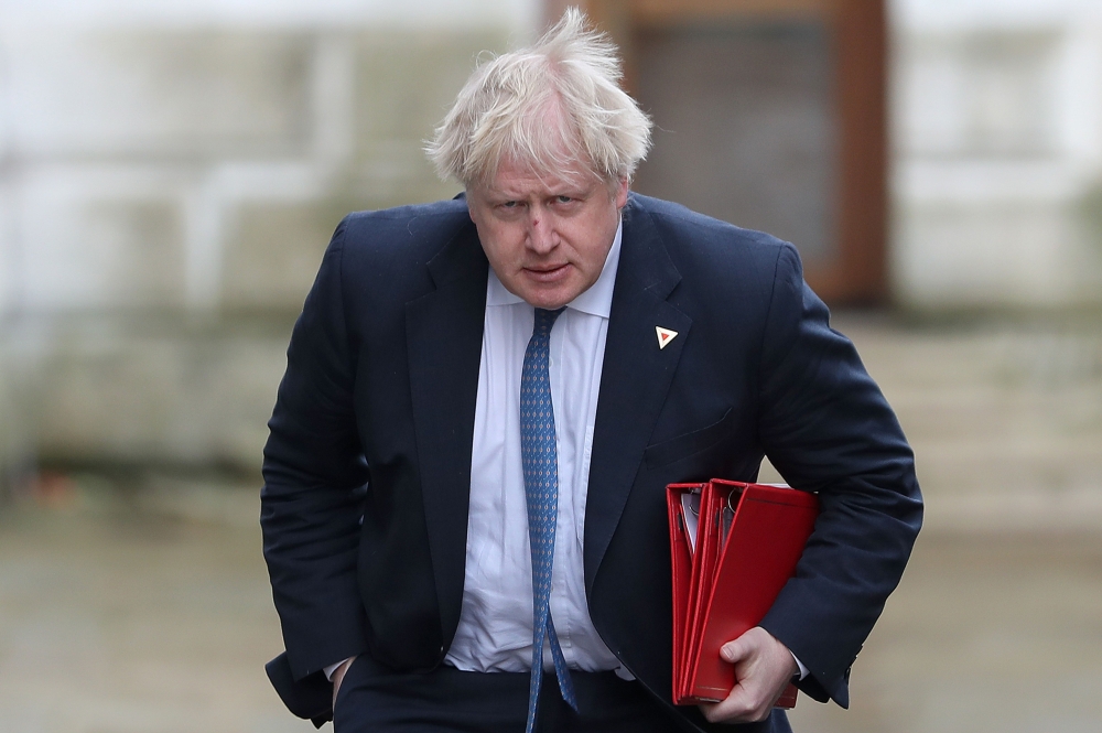 The file photo shows Britain's then Foreign Secretary Boris Johnson arriving in Downing Street in London. Britain's Conservative Party Chairman Brandon Lewis said Tuesday he had asked former foreign secretary Boris Johnson to apologize for disparaging comments he made about Muslim women wearing burqas. — AFP