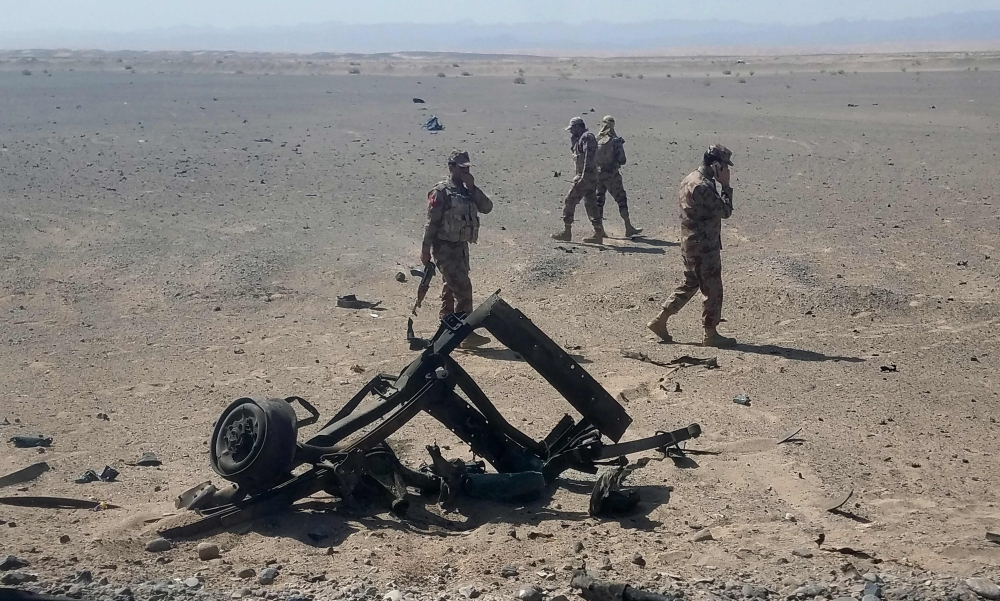Pakistani security personnel inspect the site of a suicide attack site in Dalbandin region, around 340 km from Quetta, the capital of southwestern Balochistan province, Saturday.  — AFP