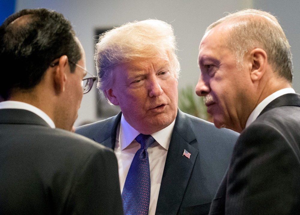 In this file photo taken on July 10, 2018, US President Donald Trump (2ndR) speaks with Turkey's President Recep Tayyip Erdogan (R) during a working dinner in Brussels, during the North Atlantic Treaty Organization summit. Trump said on Aug. 10, 2018, he had doubled steel and aluminum tariffs on Turkey. — AFP