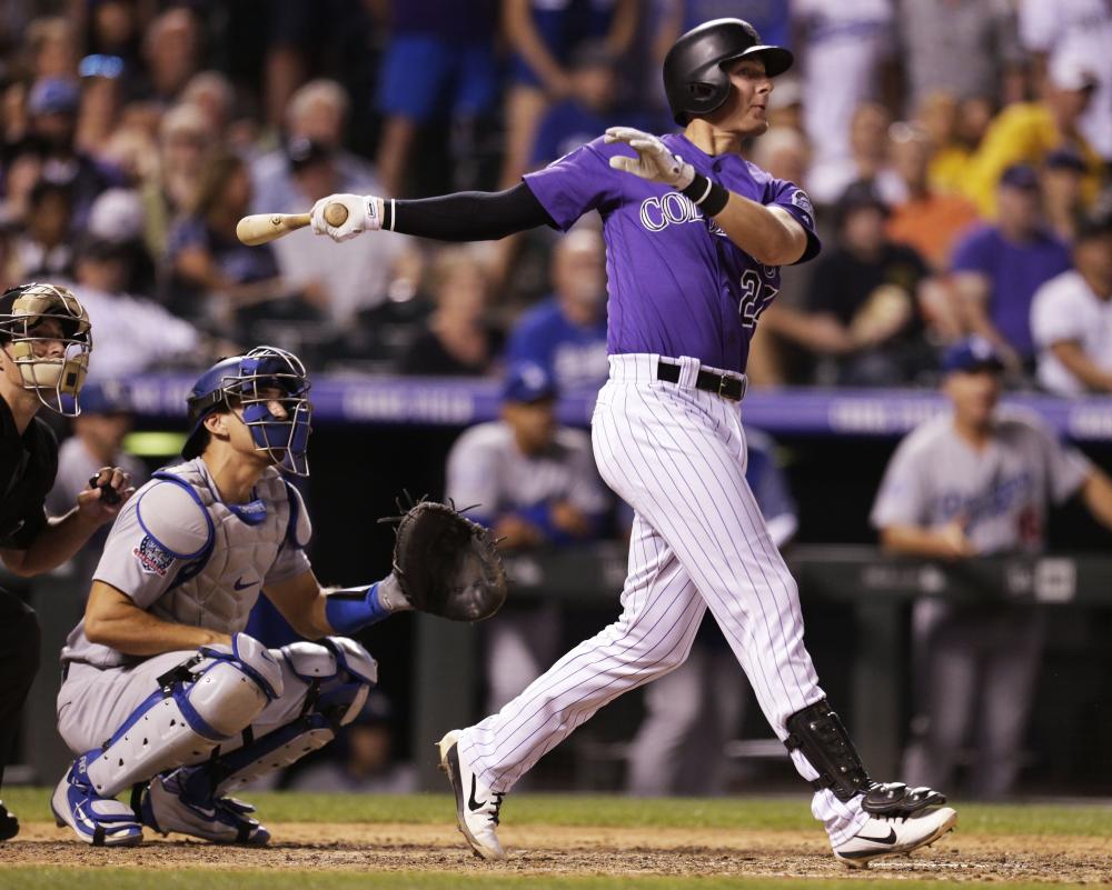 Ryan McMahon of the Colorado Rockies hits a walk-off, three-run home run as Austin Barnes of the Los Angeles Dodgers watches at Coors Field in Denver, Colorado, Saturday. — AFP 
