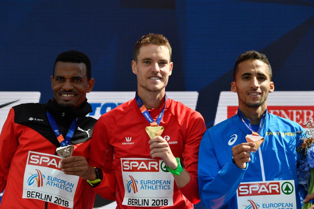 (L-R) Second place Switzerland’s Tadesse Abraham, winner Belgium’s Koen Naert and third place Italy’s Yassine Rachik pose on the podium of the men’s marathon at the European Athletics Championships in Berlin Sunday. — AFP