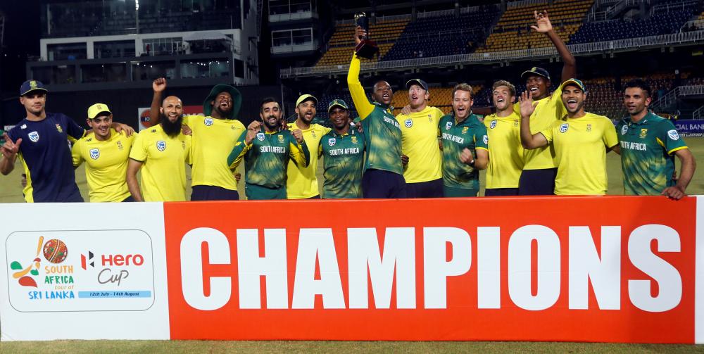 South Africa's team members pose for photographs with the trophy. — Reuters