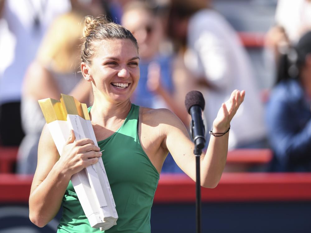 Simona Halep of Romania holds the trophy during the post game ceremony after defeating Sloane Stephens of the US in the final of the Rogers Cup in Montreal Sunday. — AFP 