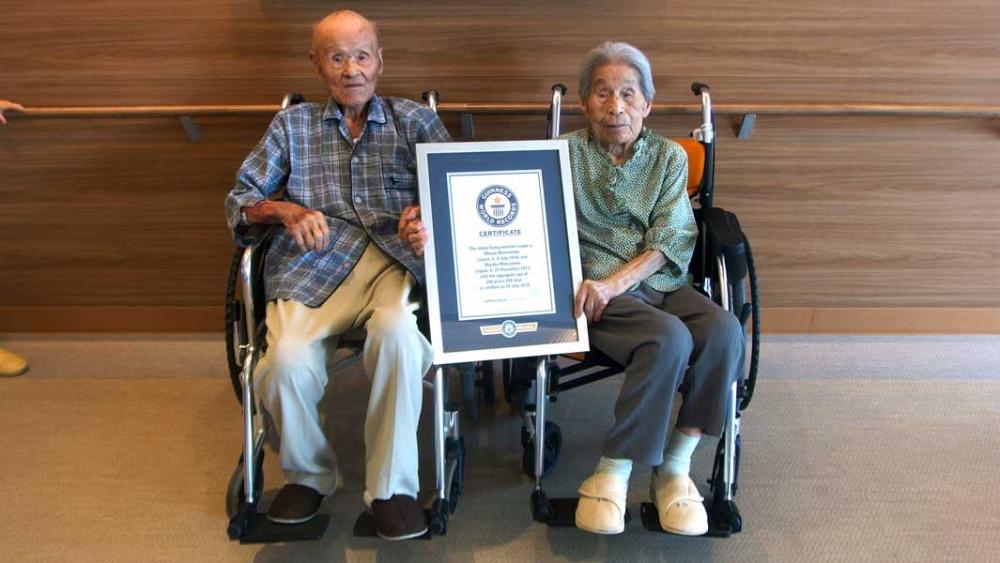 Masao Matsumoto, left and and Miyako Sonoda pose with a certificate issued by Guinness World Records after they were given the title of oldest living married couple by aggregate age.