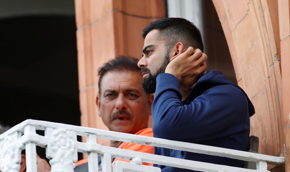 India’s head coach Ravi Shastri and Virat Kohli talk during the second cricket Test against England at Lord’s Sunday. — Reuters