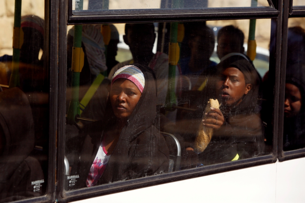 Migrants sit in the bus after disembarking from the humanitarian ship Aquarius at Boiler Wharf in Senglea, in Valletta’s Grand Harbour, Malta, on Wednesday. — Reuters