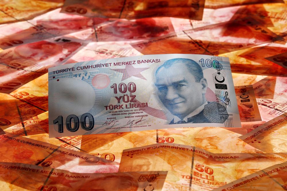 A 100 Turkish lira banknote is seen on top of 50 Turkish lira banknotes in this picture illustration in Istanbul. — AFP