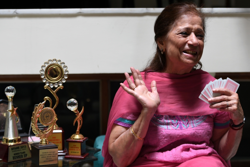 In this recent photograph, bridge player Rita Choksi, 79, gestures during an interview with AFP at her residence in New Delhi.  Age is just one of many numbers for 79-year-old bridge player Rita Choksi who will this month become one of the oldest competitors ever to take part in an Asian Games. With the cerebral sport making its Asiad debut in Indonesia, Choksi and her silver-haired teammates are aiming for medals to get one over on younger members of India's contingent. — AFP