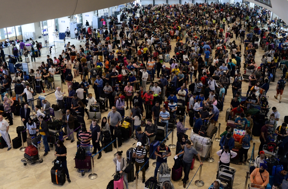 Stranded passengers wait at Terminal 1 for their flights to resume after Xiamen Airlines Boeing 737-800 Flight MF8667 overshot the runway upon landing at Ninoy Aquino International airport in Paranaque, Metro Manila in Philippines, on Friday. — Reuters