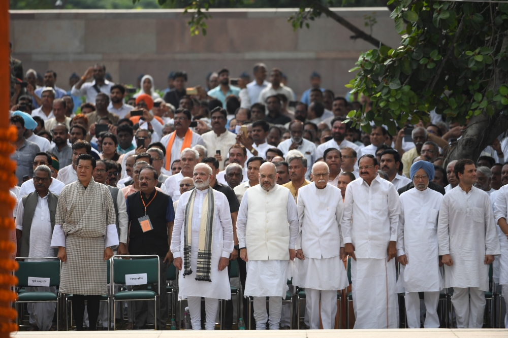 Indian Prime Minister Narendra Modi, fourth left, president of the Bharatiya Janata Party (BJP) Amit Shah, center, former Indian Prime Minister Manmohan Singh, second right, and Congress Party leader Rahul Gandhi, right, attend the funeral of former Indian Prime Minister Atal Bihari Vajpayee in New Delhi on Friday. — AFP