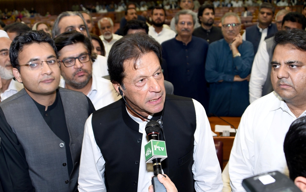 Imran Khan, center, chairman of Pakistan Tehreek-e-Insaf (PTI) political party speaks after he was elected as prime minister at the National Assembly in Islamabad on Friday. — Reuters