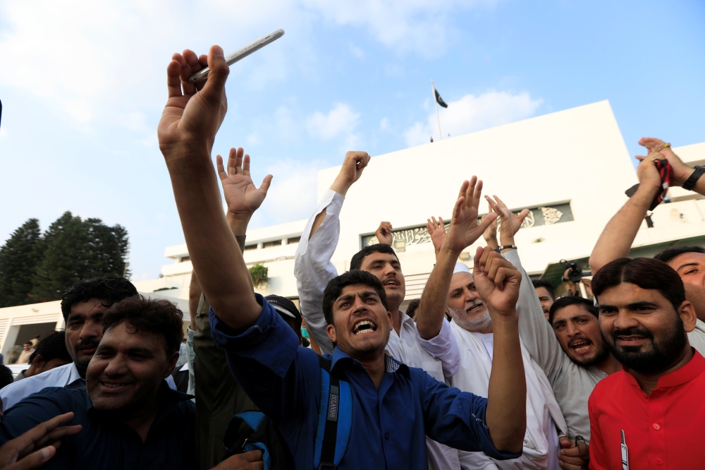 Imran Khan, center, chairman of Pakistan Tehreek-e-Insaf (PTI) political party speaks after he was elected as prime minister at the National Assembly in Islamabad on Friday. — Reuters