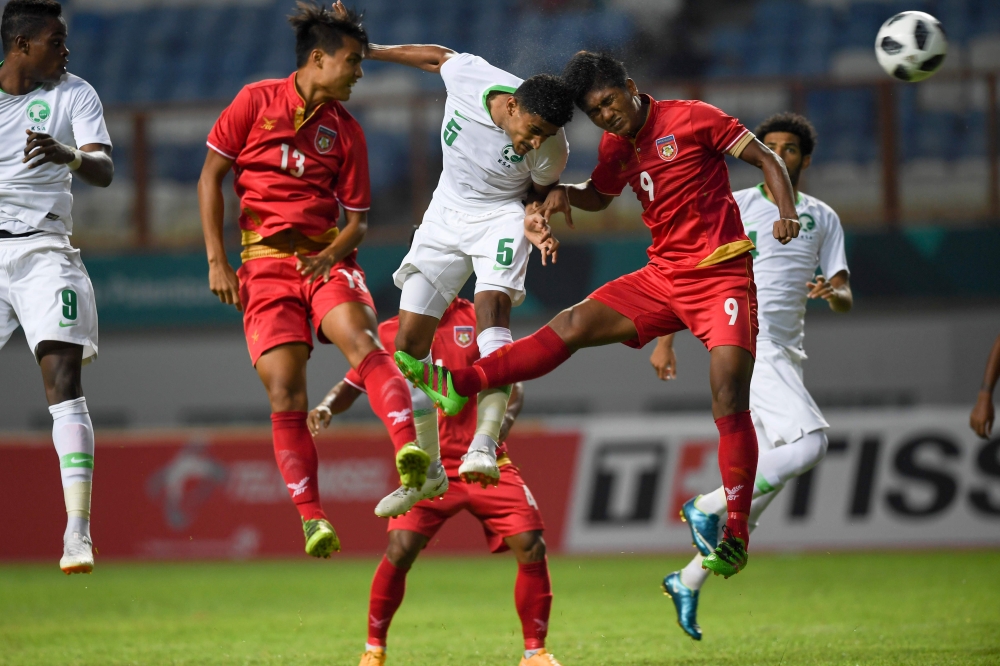 Saudi Arabia's Abdullah Ali Alamri (3L) fight for the ball with Myanmar's during the men's football Group F match between Saudi Arabia and Myanmar at the 2018 Asian Games at Cikarang on Friday. — AFP