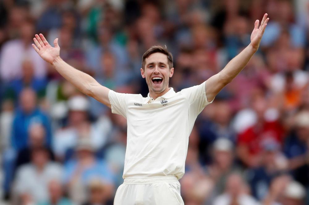 England's Chris Woakes celebrates after taking the wicket of India's Cheteshwar Pujara during the third Test at Nottingham Saturday. — Reuters