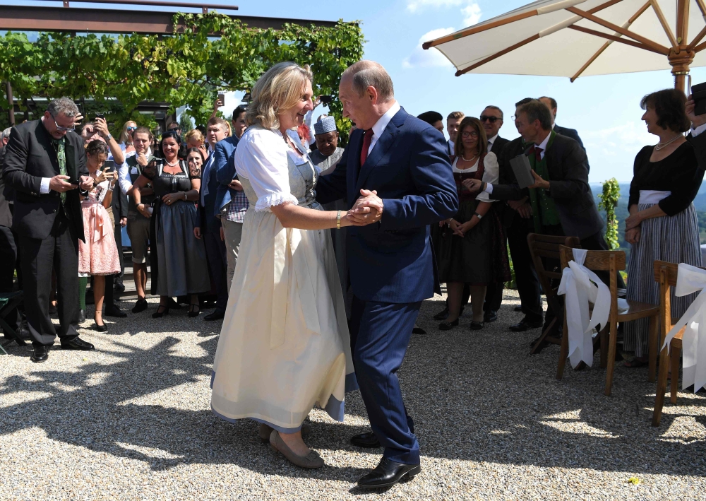 Austrian Foreign Minister Karin Kneissl and Russian President Vladimir Putin dance during her wedding in Gamlitz, Styria, Austria, on Saturday. — AFP